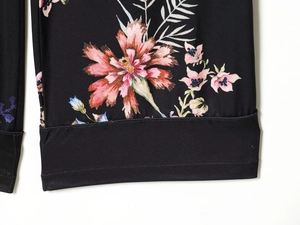 Detailed view of floral pattern print and high-quality stitching on black casual trousers