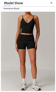 Model showing women's black yoga set with V-neck sports bra and high-waisted gym shorts