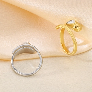 Detailed view of snake-shaped rings in gold and silver finish with clear zircon stones