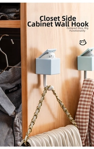 Creative wall hook with pop-up cat design showing usage on wooden closet side panel