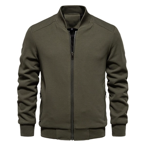 Macro detail of dark olive green waffle knit fabric and ribbed stand collar on jacket