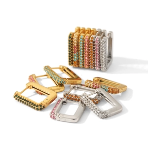 Macro view showing square huggie earrings with colorful zirconia in gold and silver