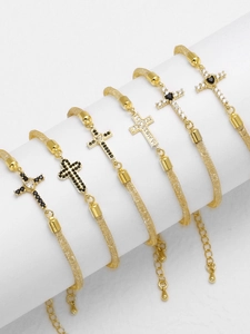 Detailed display of six 18k gold-plated mesh bracelets with cubic zirconia cross pendants