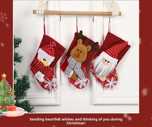 Detail of three Christmas stockings with 3D Santa, Snowman and Reindeer on rustic burlap