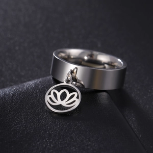 Detailed close-up of a silver stainless steel ring featuring a hollow lotus flower pendant