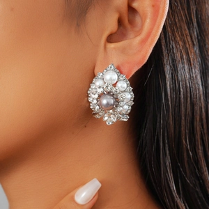 Vintage cluster flower pearl earrings with crystals and grey pearl center on a model