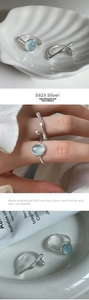 Macro view of S925 sterling silver ring featuring ice blue aurora stone and sleek band