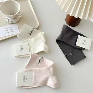 Three pairs of breathable cotton mid-calf socks in cream, pink, and charcoal grey tones