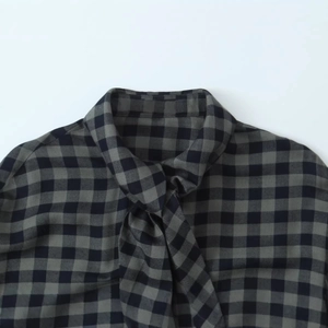 Women's vintage plaid shirt with neck tie detail and retro black and grey check pattern
