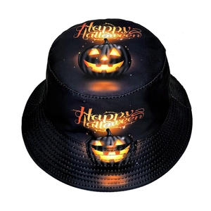 Close-up of black bucket hat featuring Happy Halloween orange pumpkin print and text