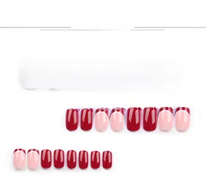 Detail of short square wine red and pink French tip press-on nails set with glossy finish
