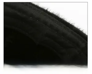 Detailed close-up of thick plush interior and fine stitching on the winter trapper hat