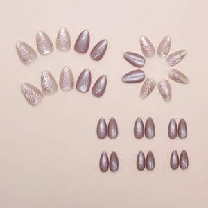 Macro detail of long almond press on nails with purple chrome and 3D bow heart designs