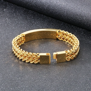 Hip hop gold Cuban chain bracelet with curved plate and magnetic clasp on black background