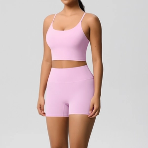Detail of high-waist yoga shorts and strappy sports bra set in lavender purple
