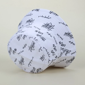 Detail of white cotton bucket hat with black graffiti embroidery and stitching on brim