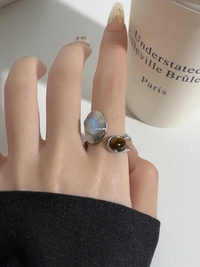 Detail of French style resin heart ring with fire opal and tiger eye stone