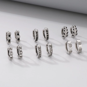 Detailed set of vintage silver earrings featuring heart patterns and black zircon stones
