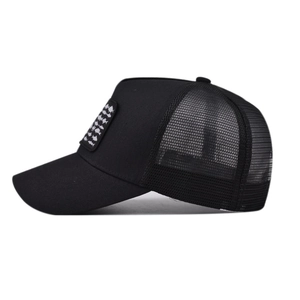 Black trucker hat with fish pattern patch and breathable mesh back in side view