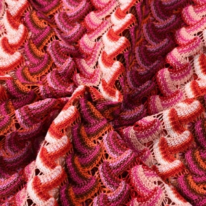 Macro view of colorful wave pattern knit fabric for a striped backless vacation maxi dress