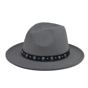 Close-up of wide brim fedora with turquoise gemstone chain and silver stud details