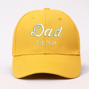 Close-up of yellow cotton baseball cap with white 3D Dad EST. 2024 embroidery details