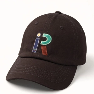 Detail of embroidered letters i and R on dark brown cotton canvas baseball cap