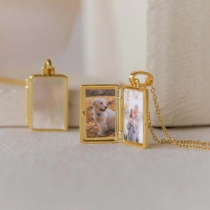 Golden locket necklace with shell inlay opening to show two small custom photos