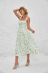 Detail of white floral sundress with side slit and delicate green flower patterns