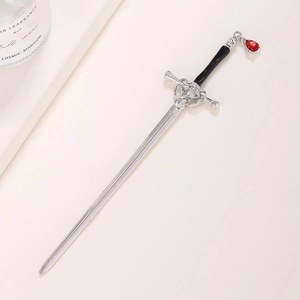 Vintage sword-shaped silver hairpin with a faceted red teardrop gemstone pendant