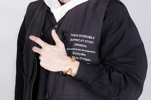 Detailed view of punk style gold wolf head bangles on a male model with streetwear style