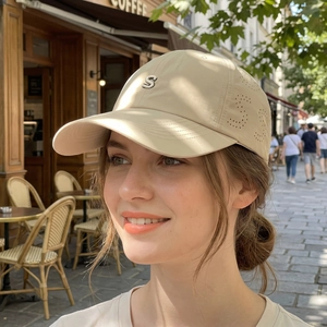 Beige quick-dry baseball cap with metal S logo and laser-cut ventilation on street