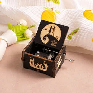 Close-up of The Nightmare Before Christmas laser engraving on black wooden music box