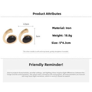 Detail showing dimensions of geometric oval gold earrings with black stone inlay