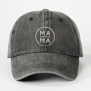 Detailed embroidery of MAMA text on washed denim fabric of a vintage baseball cap