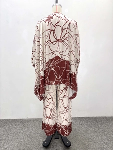 Detail of plus-size two-piece set featuring dark red floral print and wide-leg trousers