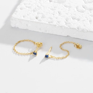 Close-up of S925 sterling silver gold chain earrings with deep blue zircon stones