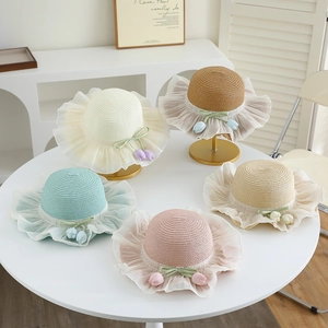 Detail of straw sun hats with floral tulip accents and mesh lace in five colors