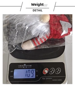 Weight measurement of a red and grey Christmas gnome plush with knitted heart cap