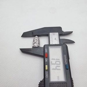 Silver cone bead spacer measured with a digital caliper showing a precise length of 13.94 mm