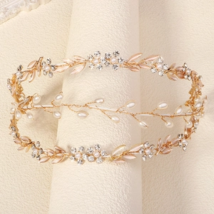 Detail of handmade bridal headband featuring white pearls and rhinestone flower clusters
