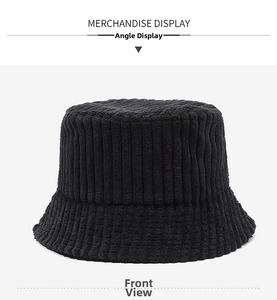 Close-up of black wide-wale corduroy bucket hat showing texture and vertical stripes