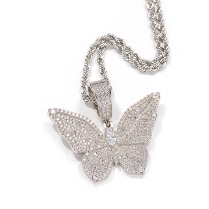 Macro view of butterfly pendant with clear cubic zirconia on a silver twist chain