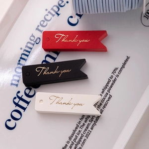 Three-color dovetail gift tags with gold foil Thank You lettering on a decorative plate
