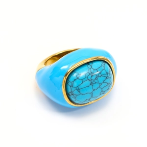 Detailed close-up of blue enamel ring with turquoise gemstone and 18k gold plating