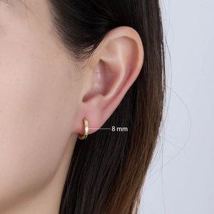 Close-up of 8mm minimalist gold hoop earring worn on model for size reference