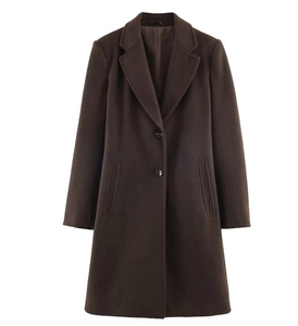 Close-up of deep brown wool coat showing tailored lapels and double-button closure