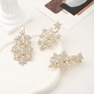 Three-piece gold rhinestone hair clip set with star, butterfly, and flower designs