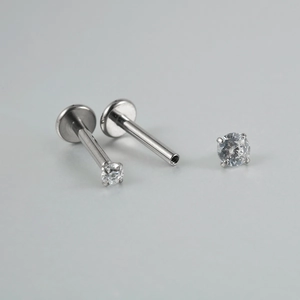 Macro view of G23 titanium labret stud with internal threads and clear cubic zirconia