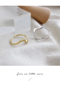 Detailed close-up of wavy S925 sterling silver rings in gold and silver finishes